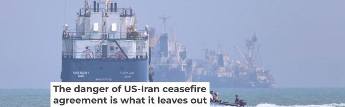A small motorboat passes anchored vessels in the Strait of Hormuz off Bandar Abbas, Iran, on June 11, 2026. Amirhosein Khorgooi/ISNA via AP